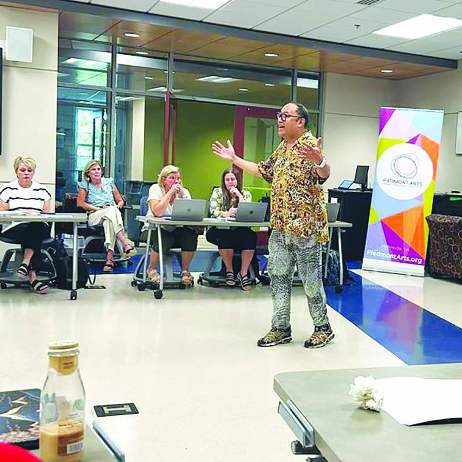 Poet Regie Cabico energetically address the 5-8 grade English teachers at the professional development session.