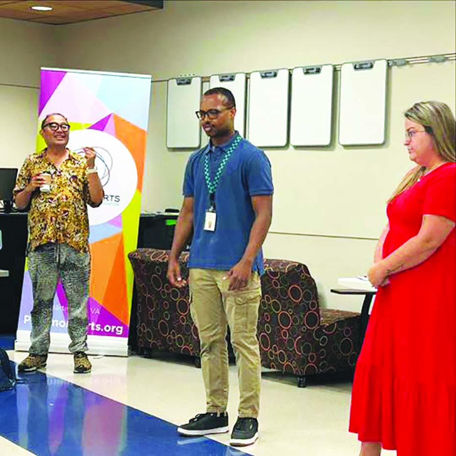 Two teachers ready to share their creations while Cabico encourages them from the sidelines.