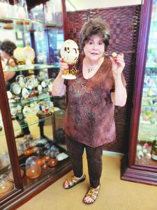 Karen Eggleston poses with two different egg projects.