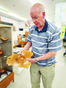 Terry Mitchell shows off a handmade bowl.