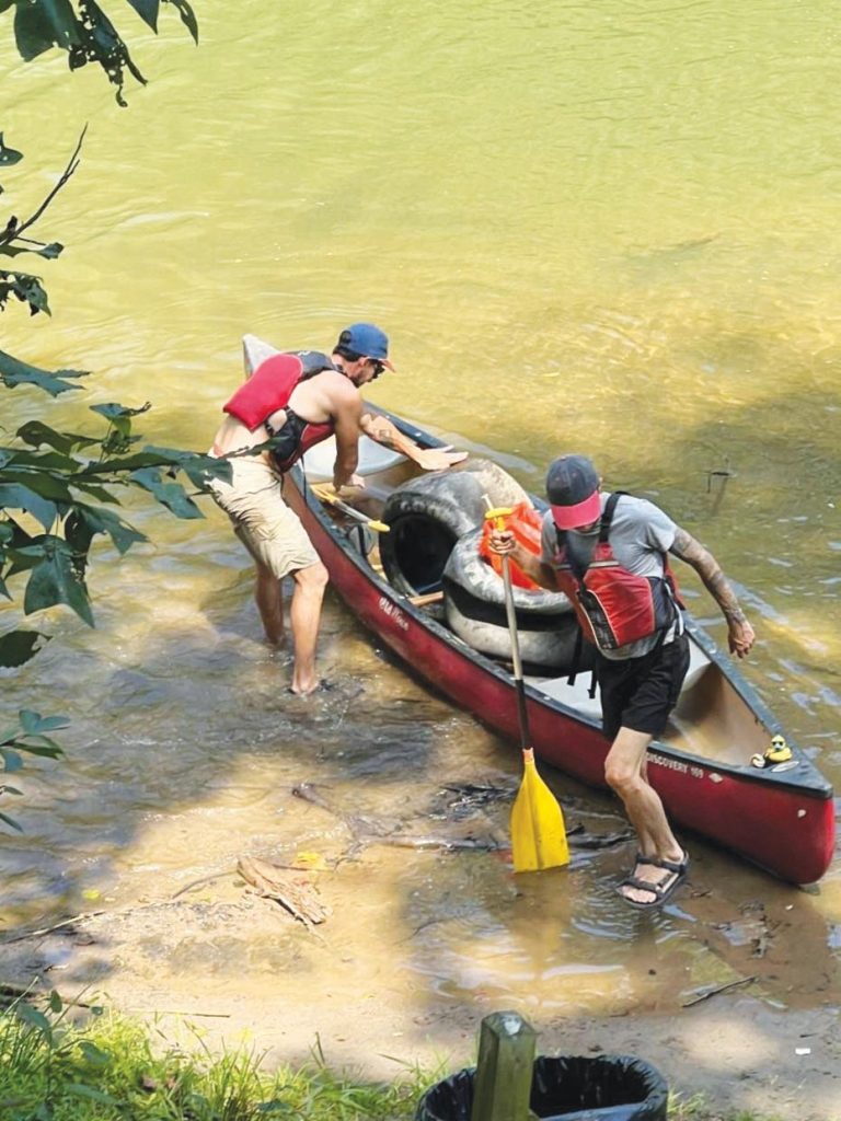 Volunteers dig tires out of the Smith River.