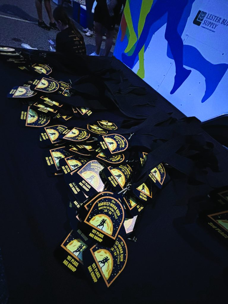 Medals lined up on the awards table according to age group. (Contributed)