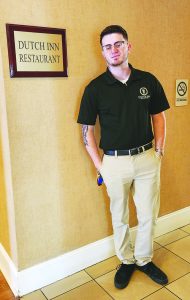 Austin Boyd stands next to the new Dutch Inn Restaurant's entrance.