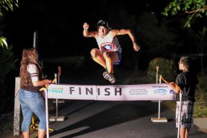 Alfredo Huerta leaps over the finish line. (Contributed)