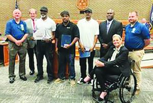 Heads of State Entertainment members Lex Hairston, Tamon Niblett, and Greg Hairston receive the Community Connected Citizen Award.