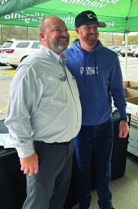 Roanoke Food Lion store manager Calvin Walters poses with NASCAR driver Jeb Burton. (Contributed)