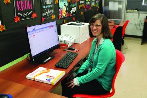 Middle College instructor Lisa Aquilo prepares materials for incoming students.