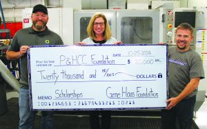 Instructors Justin Durden and Denver Smith receive a big check presented by Tiffani Underwood, P&HCC Foundation Executive Director.