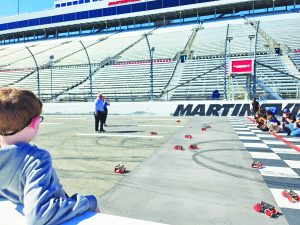 Students race their rubber band cars at the famous Martinsville Speedway starting line.