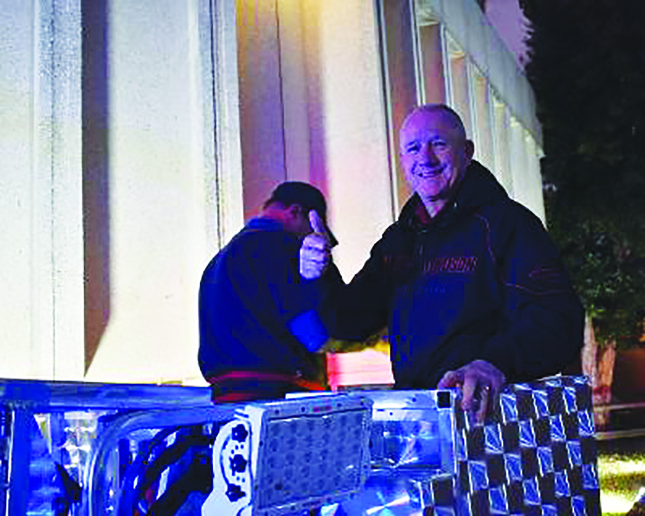 Joe Bryant of the Collinsville District gives a thumbs-up as he inspects the new truck’s ladder.