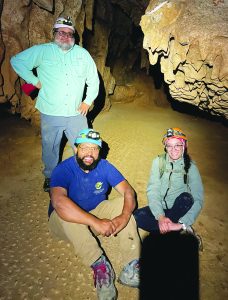 Ángel A. García, Jr. (sitting, left), along with colleague Ángel A. Acosta-Colón (standing) and student Bianca Maldonado-Arroyo, inside Endless Caverns where the team collected the cave shield.
