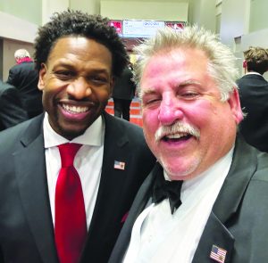 Pastor Lorenzo Sewell, who delivered astirring inaugural prayer, is pictured with
Ray Reynolds.