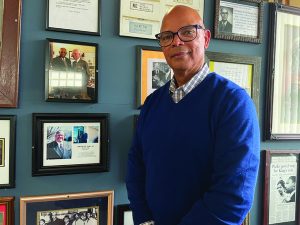 James Dallas stands beside a photo of his father, Bruce H.T. Dallas, Sr., whose legacy he hopes to honor with future projects.