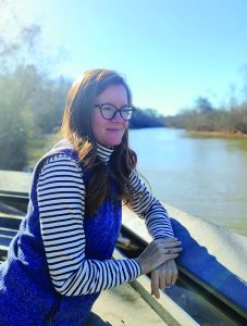 Krista Hodges standing alongside the Dan River in Danville. (Photo by DRBA)
