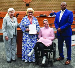 Kerry Walker holds the proclamation presented by the Henry County Board of Supervisors.