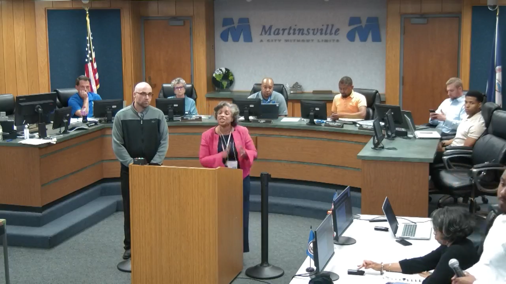 City Manager Aretha Ferrell-Benevides responds to questions during a May 6 meeting. Martinsville City Council members are pictured in the background.