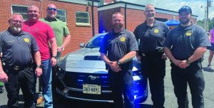 Del. Eric Phillips, R-Martinsville, posed with Henry County Sheriff Davis and several officers before the pie-eating contest.