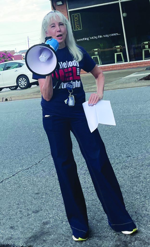 Delegate candidate Melody Cartwright addresses the crowd outside the city municipal building.
