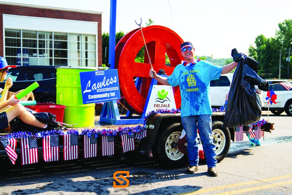 Chris Lawless makes a splash with a working water wheel on his float, echoing the parade’s splash theme.