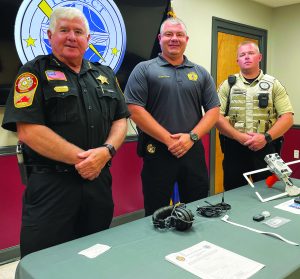 Martinsville Sheriff Steve Draper, Henry County Sheriff Wayne Davis, and Deputy Matthew Wiggington demonstrate Project Lifesaver.