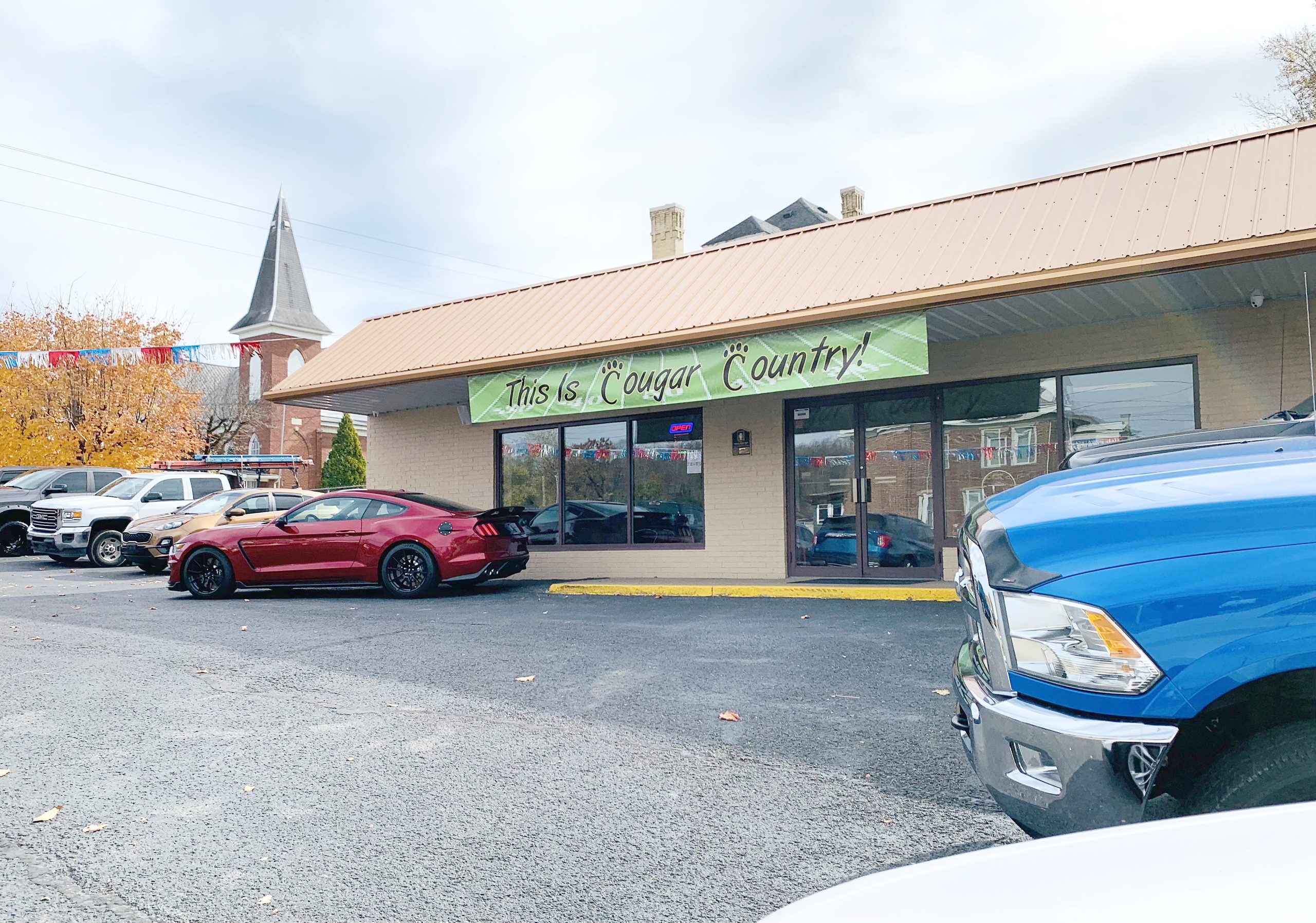 storefront has "This is Cougar Country" sign