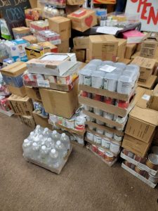 boxes of canned food, bottled water