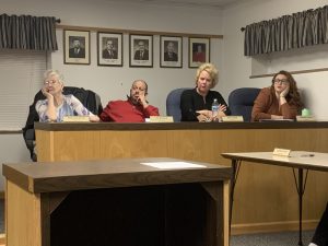 Councilmembers appear to be listening closely as Police Chief Harbert speakers.