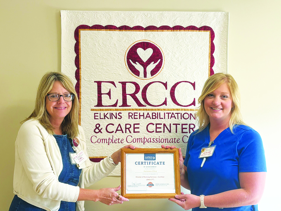 Elkins Rehabilitation & Care Center Director of Nursing Autumn Elza, at right, receives a Certificate of Achievement fro