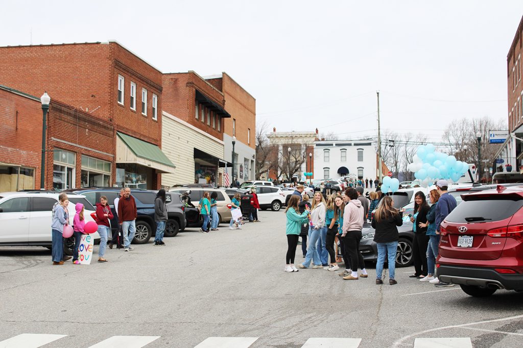 A crowd of onlookers gathered in uptown Stuart Friday to welcome Lauren Worley home.