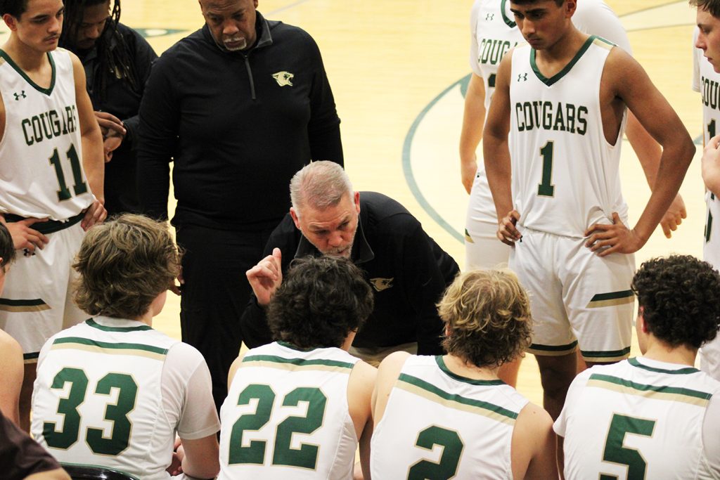 Head Coach Brian Chitwood talks with this team during a timeout.