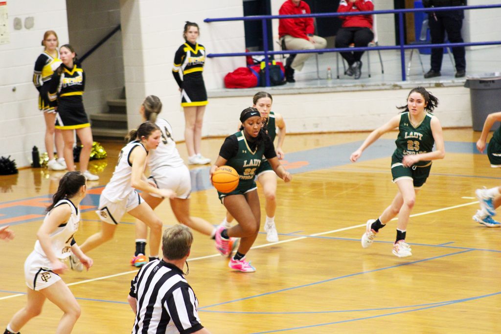 After grabbing a rebound, Aniya Penn heads up court.