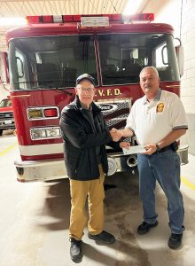 Patrick Henry Volunteer Fire Department Assistant Chief Tommy Hudson received a $500 check from the Stuart Rotary Club. The department serves both Henry and Patrick counties.