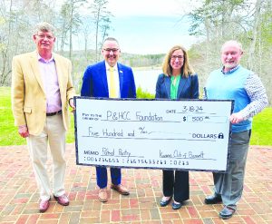 P&HCC President Dr. Greg Hodges and P&HCC Foundation Executive Director Tiffani Underwood accept a donation to support Patriot Pantry from Stu Warren (L) and Tim Stone (R) of Bassett Kiwanis Club.