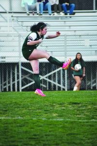 Kendall Williams kicks the ball down field.