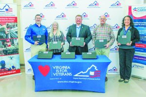 In the photo: Jack Raymondson (T4T), Rosemary Bowers (P&HCC), John Hall (MEWI), Jack Hanbury (P&HCC), and Morgan Hyde (VDS) celebrate the start of the Virginia Veteran Laptop Project at P&HCC.