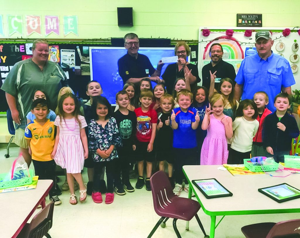 From top left: Mrs. Foley (kindergarten teacher), David Clement (Ruritan President) present a donation to Mrs. Whitlow, principal, Kenneth Reynolds and Billy Corns (Ruritan members) and Mrs. Foley’s kindergarten class.