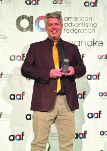 David Stanley, owner and art director of SilverLining Design, is pictured with a Silver ADDY Award at a March 2 awards ceremony in Roanoke.