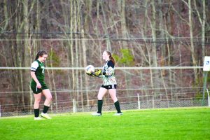 Skye Ayers prepares to kick the ball after a save in the goal.