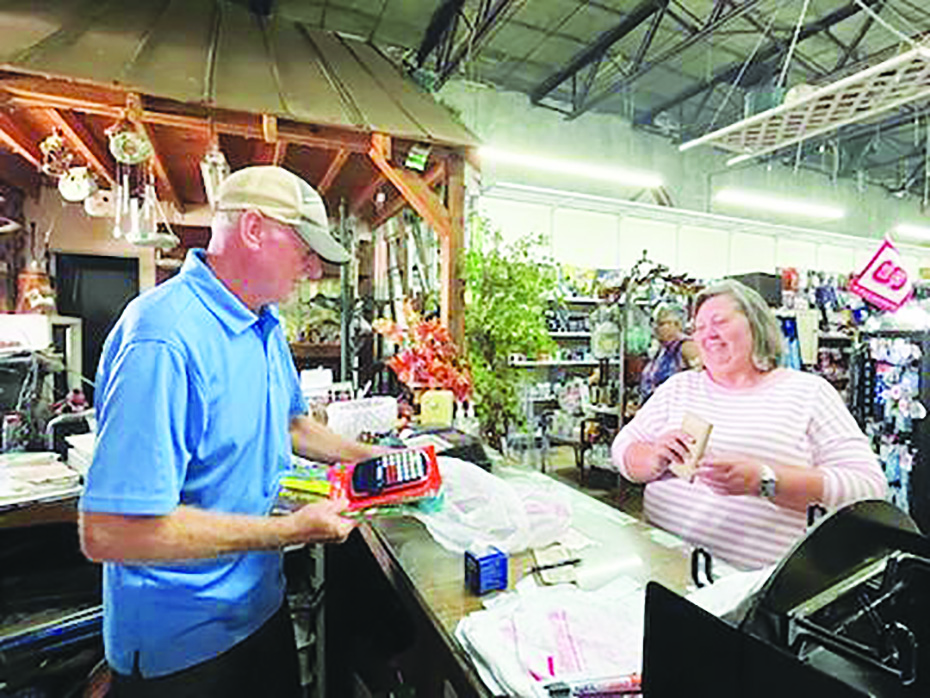 Stanley Fain interacts with a customer at All Seasons in Patrick Springs. After 33 years in business, Fain and his wife Jennifer are planning to retire.