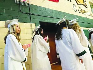 Lauren Worley prepared to walk across the stage and receive her diploma. She was severely injured in a December car crash