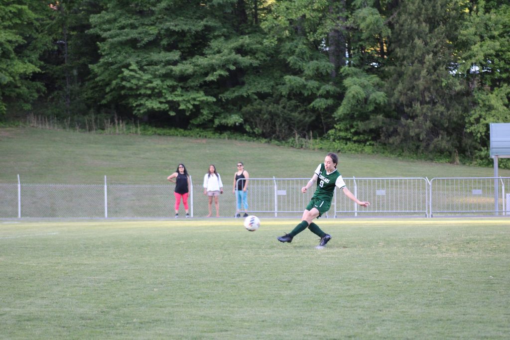 Kyra Titular fires a shot on goal.