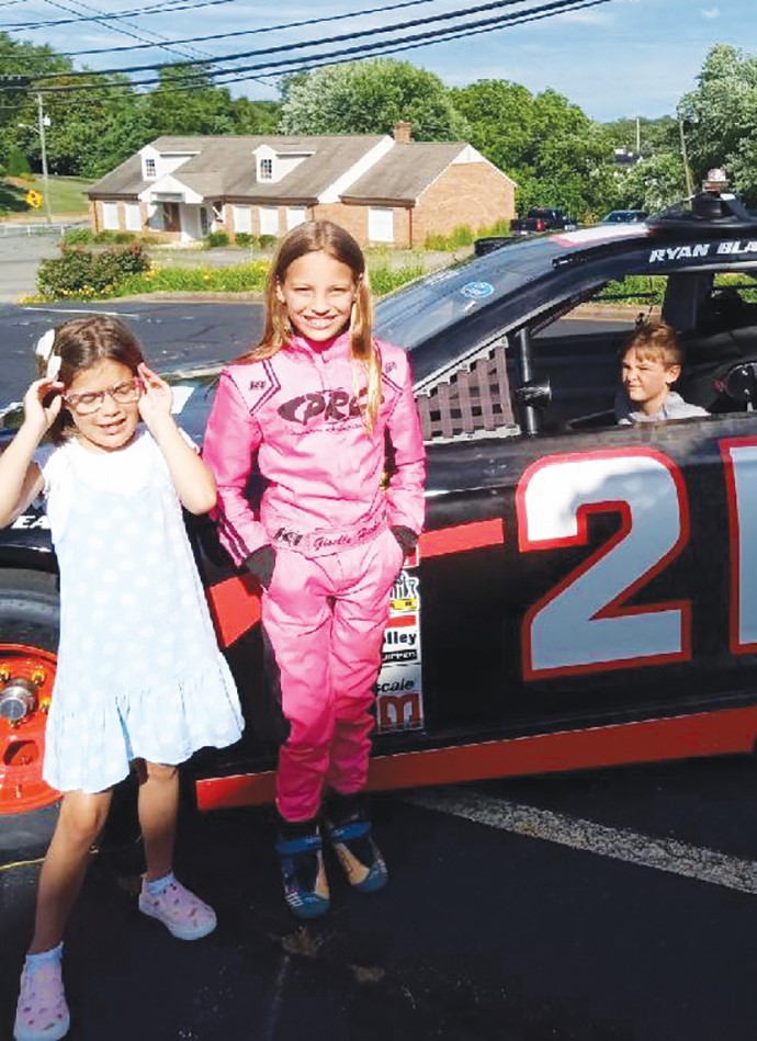 Giselle Hicks (center), and her sister, Londan (left) treated VSB participants to a behind-the-scenes look at the work and dedication involved in racing and then going on to win a race.