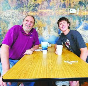 Nate Large is pictured celebrating with Tom Perry at Boyd's Restaurant. 