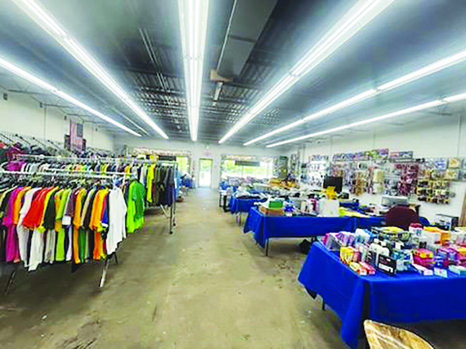 The store sells a variety of items including clothing, belts, hats, glassware, and other items.