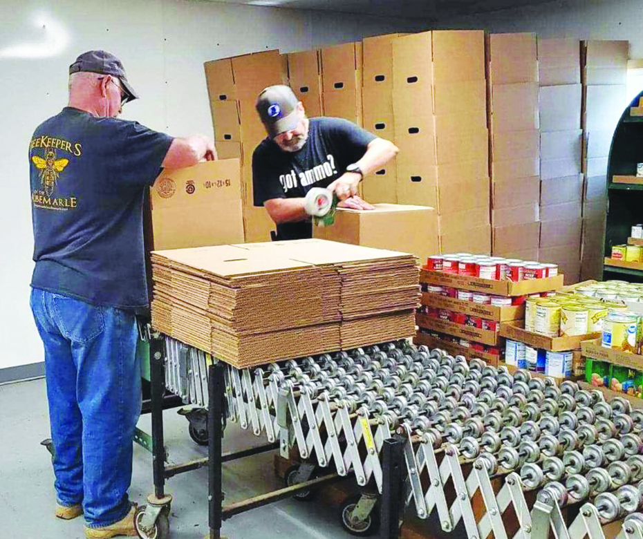 Patrick County Food Bank volunteers work to pack food boxes to be passed out.