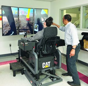 Michael Scales, P&HCC’s HEO instructor, guides a student through a simulator exercise.