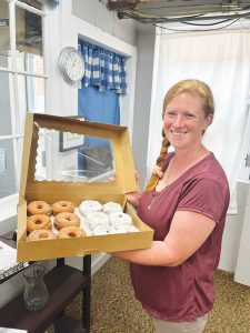 Heather Eubanks bakes a variety of donuts including powdered sugar and cinnamon sugar.