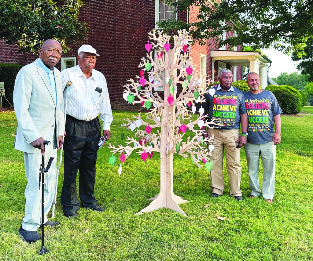 Three generations of descendants of Kitty Penn Reynolds stand near the historic home at Reynolds Homestead. Left to right: Dana Reynolds and Reverend Eugene Reynolds (Kitty’s grandsons); Richard A. Reynolds (Kitty’s great-grandson) and Kimble J. Reynolds Jr. (Kitty’s great-great-grandson). (Photo by Julie Walters Steele for Virginia Tech)