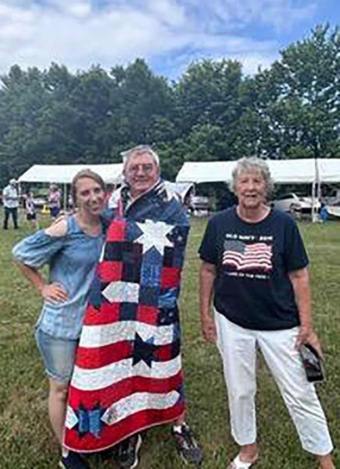 Richard Conner and his wife Ann accepted the quilt made by Leah Eckman.