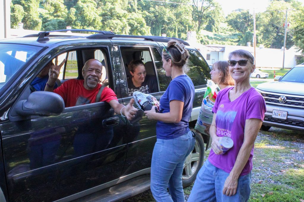 PAWS members distribute pet food at a project that was made possible by donations from the county and a partnership between PAWS and the Patrick County Food Bank.